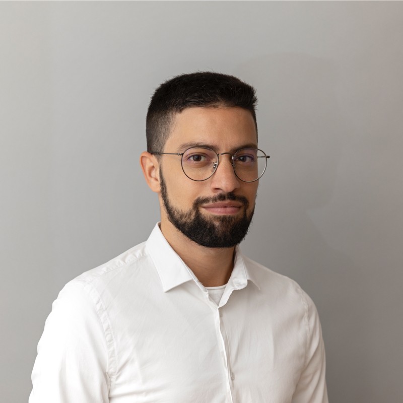 Müfit Sahin, Talent Partner, in a white shirt against a gray background